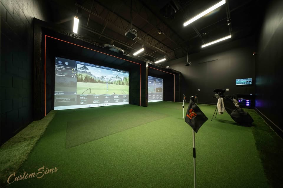 Two-bay commercial golf simulator build with tour-quality turf